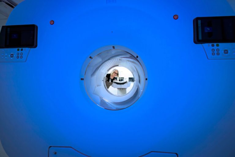 Karin Rexroad Peeks Through The Bore Of The Pet Ct Scanner 1100x733.jpg