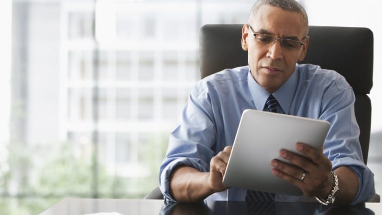 Businessman Looking Over Electronic Tablet.jpg